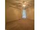 Clean bedroom featuring carpet, fan lighting, and access to the rest of the house at 7929 Roy Rd, Indianapolis, IN 46219