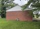 Side view of a brick home with a well-maintained lawn and mature trees at 7929 Roy Rd, Indianapolis, IN 46219
