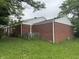 Exterior shot of a brick home with a well-maintained lawn and mature trees at 7929 Roy Rd, Indianapolis, IN 46219