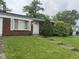 Charming single-story home featuring a well-maintained lawn and mature landscaping with a decorative dog statue at 7929 Roy Rd, Indianapolis, IN 46219
