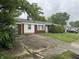 Charming single-story home featuring a well-maintained lawn and an attached one car garage with a damaged driveway at 7929 Roy Rd, Indianapolis, IN 46219