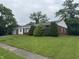 Charming single-story home with mature landscaping and an attached one-car garage perfect for suburban living at 7929 Roy Rd, Indianapolis, IN 46219