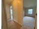 Hallway with carpet leading to the bedroom with light walls, and a view of a window at 7929 Roy Rd, Indianapolis, IN 46219
