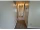 Neutral hallway featuring carpet and white trim, connecting different areas of the house at 7929 Roy Rd, Indianapolis, IN 46219