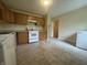 A functional kitchen is ready for cooking, featuring tile flooring and appliances at 7929 Roy Rd, Indianapolis, IN 46219