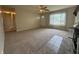 Bright living room with a ceiling fan, a brick fireplace and large windows, creating a warm and inviting atmosphere at 7929 Roy Rd, Indianapolis, IN 46219