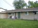 Backyard featuring a well-maintained lawn, an air conditioning unit, and a back door at 80 Brentwood Dr, Mooresville, IN 46158