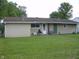 View of the backyard, with a large grass area, and rear entrance at 80 Brentwood Dr, Mooresville, IN 46158