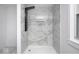 Modern bathroom with marble-look tiling and glass shower stall with black shower system at 805 N Euclid Ave, Indianapolis, IN 46201