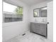 Bathroom featuring double sinks, grey cabinets, and modern fixtures, with marble-look flooring at 805 N Euclid Ave, Indianapolis, IN 46201