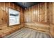 Bedroom featuring knotty-pine paneling, laminate flooring, and natural light, offering rustic charm at 805 N Euclid Ave, Indianapolis, IN 46201