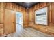 Room featuring knotty-pine paneling, laminate flooring, and natural light, offering rustic charm at 805 N Euclid Ave, Indianapolis, IN 46201