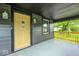 Covered porch with a bright yellow front door, sidelights, and black trim at 805 N Euclid Ave, Indianapolis, IN 46201
