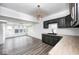 Kitchen and bright eating area with modern cabinetry, stainless steel appliances, and wood look flooring at 805 N Euclid Ave, Indianapolis, IN 46201