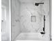 Modern bathroom with a stylish marble tiled shower and sleek black fixtures at 815 E 24Th E St, Indianapolis, IN 46205