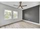 Bright bedroom with hardwood floors, ceiling fan, and natural light from the double windows at 815 E 24Th E St, Indianapolis, IN 46205