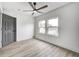 Bright bedroom with ceiling fan, updated floors, and large windows at 815 E 24Th E St, Indianapolis, IN 46205