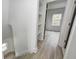 Hallway featuring shelves and hardwood floors with a view into the bedroom at 815 E 24Th E St, Indianapolis, IN 46205