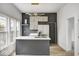 Modern kitchen with stainless steel appliances, island, and bright windows at 815 E 24Th E St, Indianapolis, IN 46205