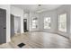 Open living room with modern lighting and updated floors with view of entrance at 815 E 24Th E St, Indianapolis, IN 46205