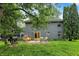 Lush backyard featuring an outdoor patio, mature trees, a grill, and the home's exterior at 8272 Calgary Ct, Indianapolis, IN 46268
