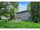 Expansive backyard with patio, grill, and generous lawn space and mature trees at 8272 Calgary Ct, Indianapolis, IN 46268