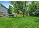 Large, well-maintained backyard with a patio area, grill, and lush green lawn at 8272 Calgary Ct, Indianapolis, IN 46268