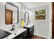 Modern bathroom with dual sinks, matte black fixtures, and a window at 8272 Calgary Ct, Indianapolis, IN 46268