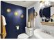 Stylish powder room with navy walls, decorative mirrors, and unique lighting fixtures at 8272 Calgary Ct, Indianapolis, IN 46268