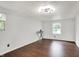 Bright, vacant bedroom featuring hardwood floors and natural light from two windows at 8272 Calgary Ct, Indianapolis, IN 46268