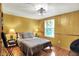 Cozy bedroom with a queen-sized bed, decorative light fixture, and a bright window at 8272 Calgary Ct, Indianapolis, IN 46268