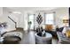Bright living room with hardwood floors, decorative wall art and comfortable gray furniture at 8272 Calgary Ct, Indianapolis, IN 46268
