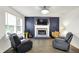 Cozy living area with a fireplace, hardwood floors, and comfortable reclining chairs at 8272 Calgary Ct, Indianapolis, IN 46268