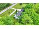 An aerial shot featuring the house with a sprawling yard, mature trees, and a private driveway at 8301 E County Road 801 S, Plainfield, IN 46168