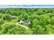 An aerial view of the charming two-story home with mature trees and a long driveway at 8301 E County Road 801 S, Plainfield, IN 46168