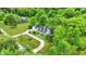 An aerial view of a home surrounded by mature trees and a barn on a lush green lot at 8301 E County Road 801 S, Plainfield, IN 46168