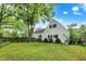 Green backyard showcasing mature trees and manicured bushes at 8301 E County Road 801 S, Plainfield, IN 46168