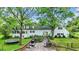 A backyard featuring a wooden deck, pool, and mature trees providing shade and privacy at 8301 E County Road 801 S, Plainfield, IN 46168