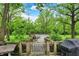 Backyard view of the covered pool with decking, surrounded by trees and lush greenery at 8301 E County Road 801 S, Plainfield, IN 46168