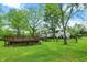 Large backyard featuring mature trees and deck at 8301 E County Road 801 S, Plainfield, IN 46168