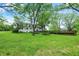 Large backyard featuring mature trees and deck at 8301 E County Road 801 S, Plainfield, IN 46168