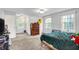 Bright bedroom featuring a neutral color palette, three windows, and carpeted floors at 8301 E County Road 801 S, Plainfield, IN 46168
