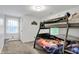 Bedroom with bunk beds featuring a neutral color palette, with natural light and carpeted floors at 8301 E County Road 801 S, Plainfield, IN 46168