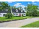 Charming white home with black shutters, a red door, and a well-kept lawn at 8301 E County Road 801 S, Plainfield, IN 46168