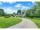 Elegant white home with black shutters and a red front door, set on a spacious, green lawn at 8301 E County Road 801 S, Plainfield, IN 46168