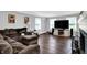 Cozy living room featuring wood floors, a comfortable sofa, and a large TV at 8301 E County Road 801 S, Plainfield, IN 46168