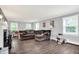 Spacious living room with wood floors, a comfy couch, and natural light from multiple windows at 8301 E County Road 801 S, Plainfield, IN 46168