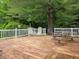 Spacious back deck featuring chairs, table, white railing and wood flooring at 8310 Dog Trot Ln, Morgantown, IN 46160