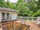 Inviting back deck with table, chairs, porch swing and a beautiful wooded view at 8310 Dog Trot Ln, Morgantown, IN 46160