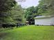 Expansive backyard featuring a playset and surrounded by mature trees at 8310 Dog Trot Ln, Morgantown, IN 46160
